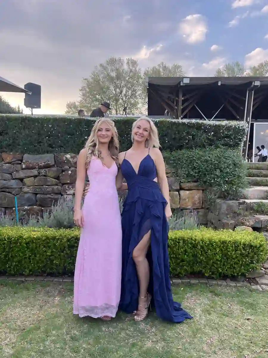 Phone snapshot of the same two guests in evening dresses