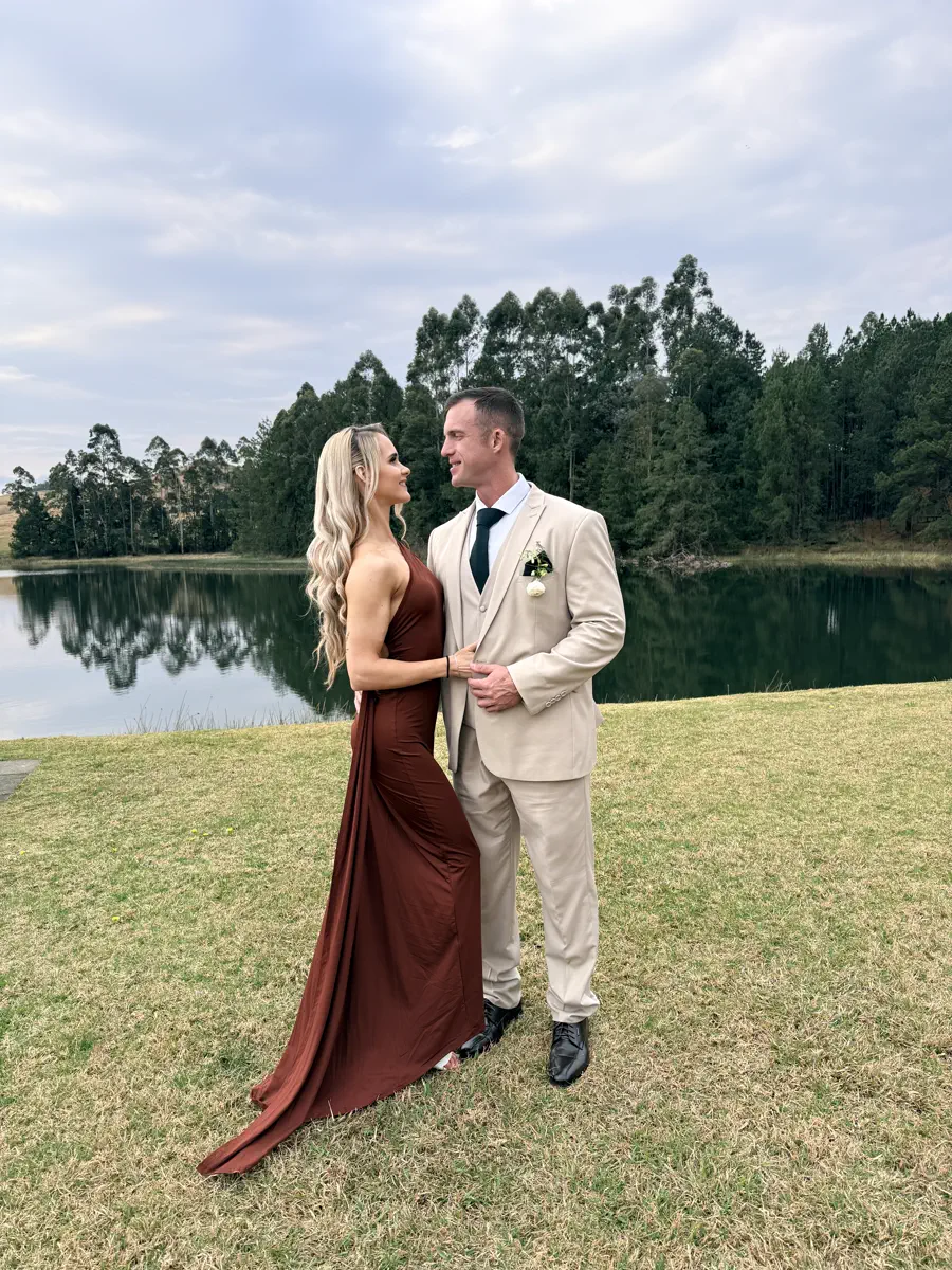 Phone snapshot of the same bride and groom beside the lake at a KZN wedding venue