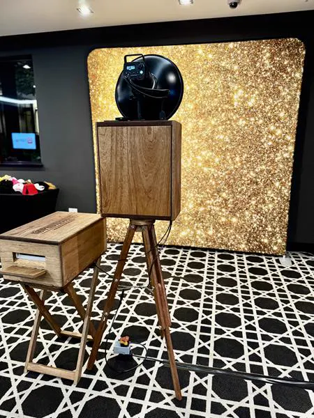 The Retrobooth and printer against a gold glitter backdrop at a corporate function in Durban