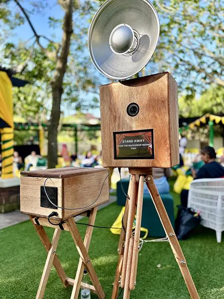The Retrobooth on its tripod at an outdoor garden party under the trees in KZN