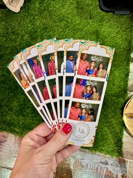 A fan of gold-bordered photostrips from an Indian wedding in Durban, guests in saris and traditional dress