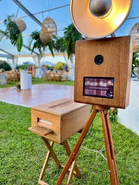 The Retrobooth on the lawn at a marquee wedding with hanging lanterns and greenery in KZN
