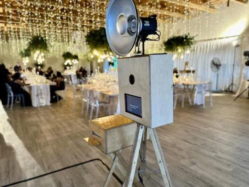 The whitewashed Retrobooth on the dance floor at a KZN wedding reception under fairy light curtains