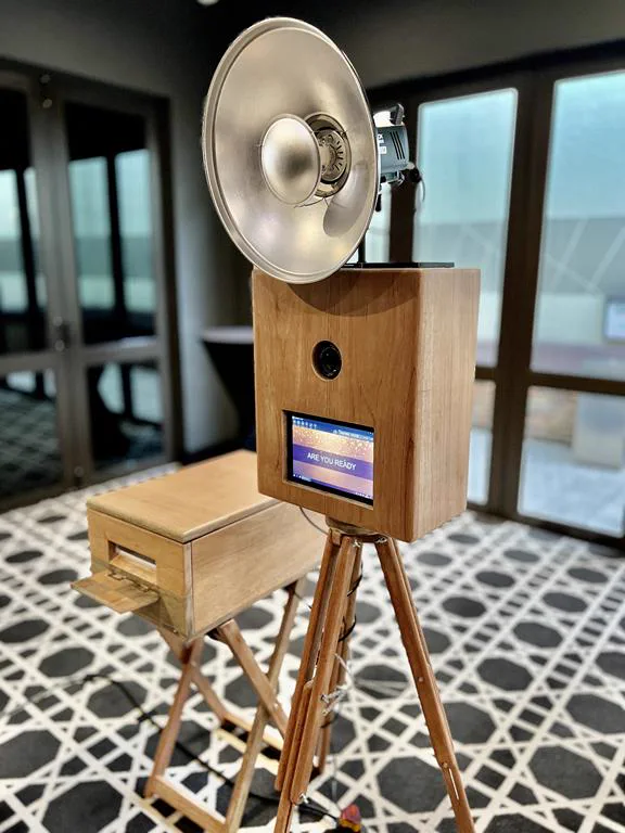 The Retrobooth's wooden housing with its studio ring flash and DSLR camera, set up at a Durban event