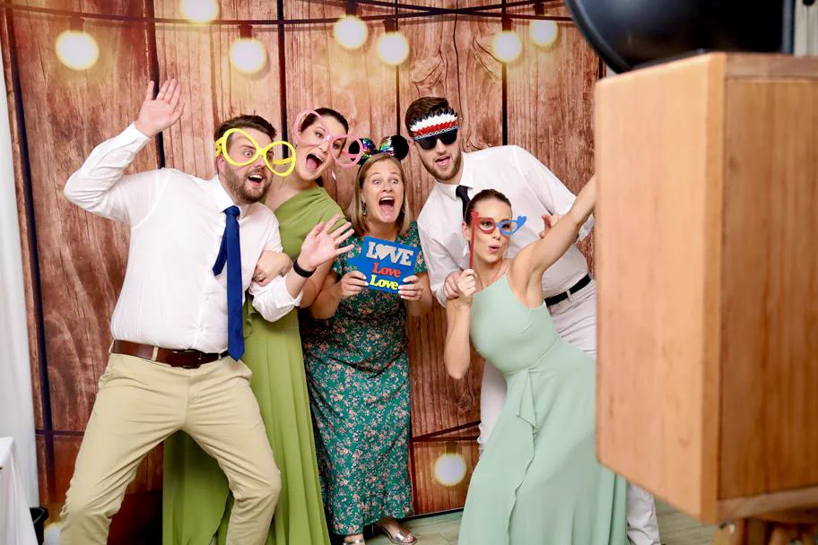 Guests posing with props in front of the Retrobooth at a Durban wedding