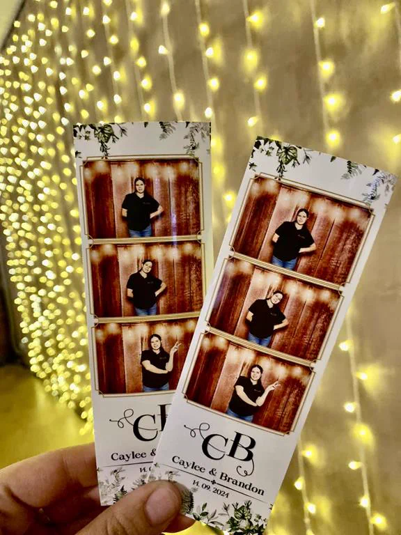 Caylee and Brandon botanical photostrips held in front of a fairy light curtain at a Durban wedding