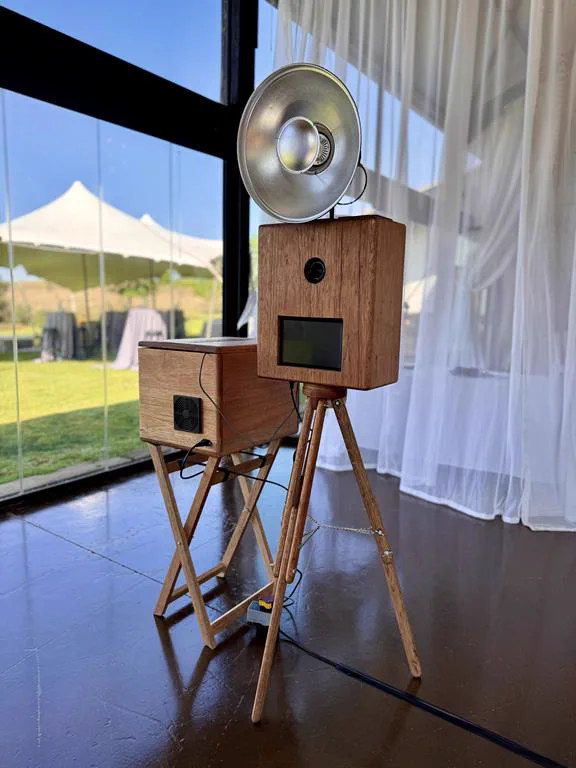 The handcrafted wooden Retrobooth on its tripod with a silver ring flash, set up at a Durban wedding venue